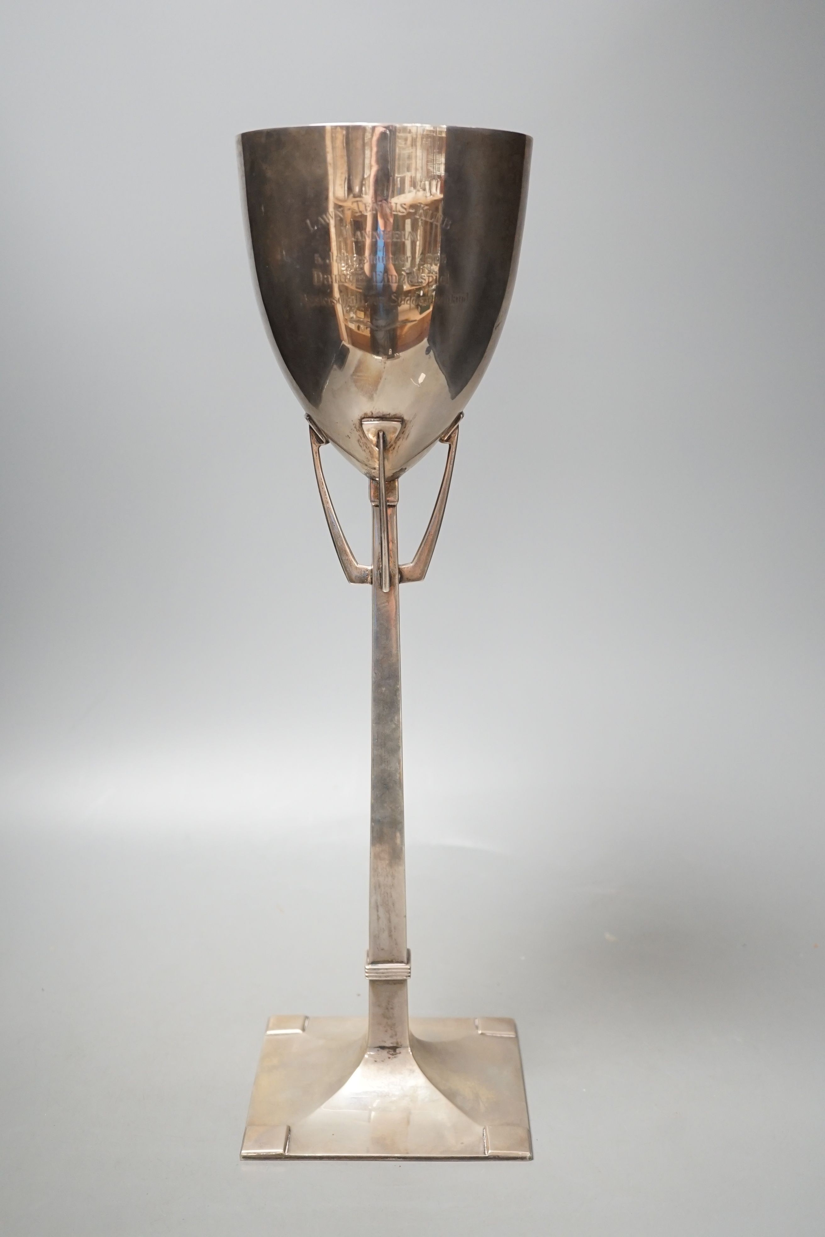 A stylish early 20th century German 800 standard white metal presentation trophy cup, with engraved inscription dated 1905, indistinct makers mark, height 42,1cm, 22oz.